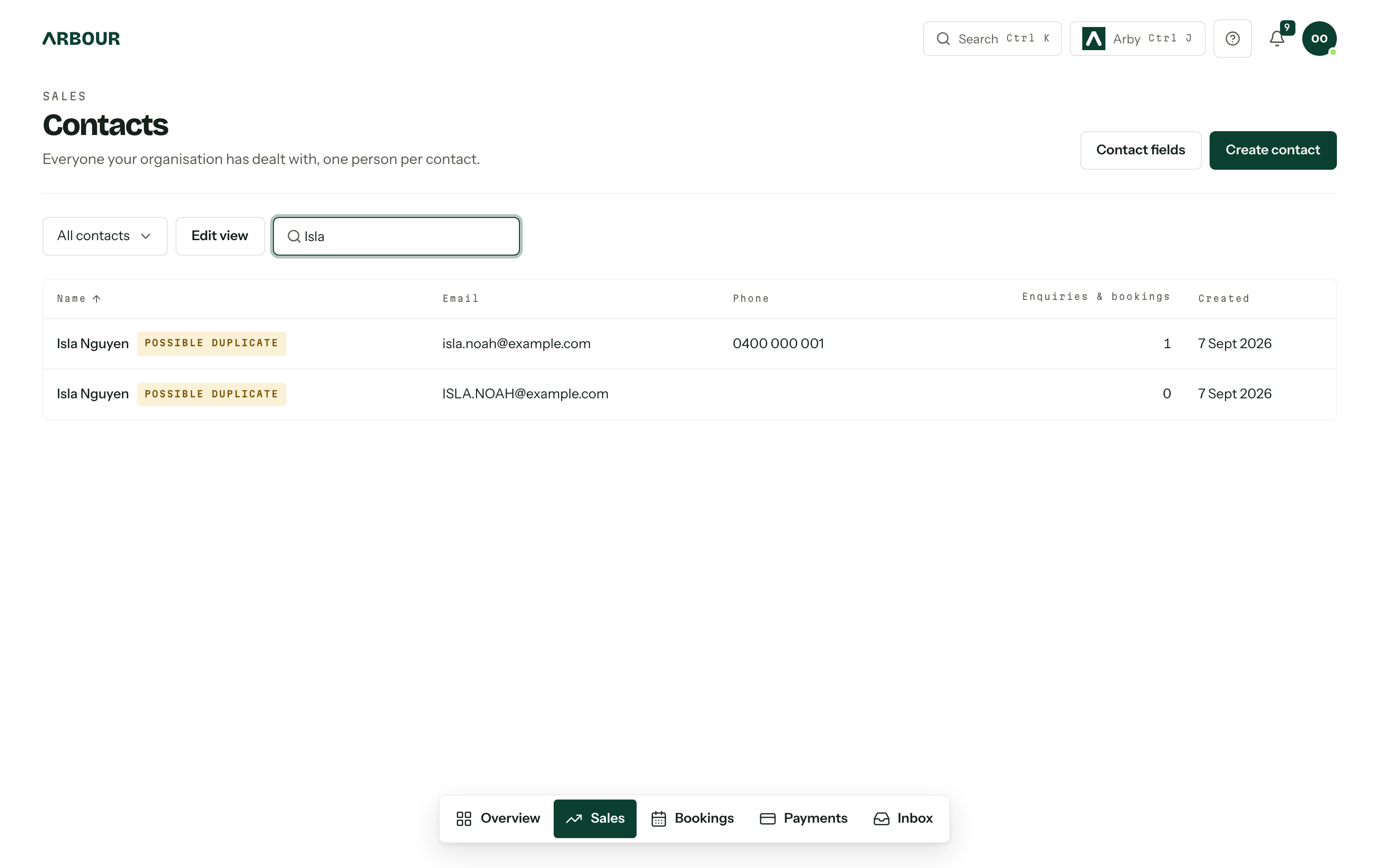 The contacts list filtered to Isla, showing two possible duplicates with their email, phone, linked jobs and created date.